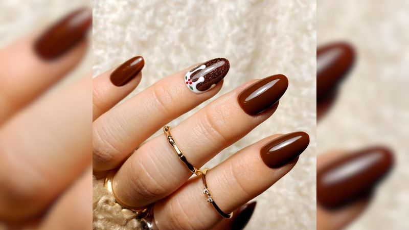 Combinar a cor marrom sólida com uma nail art mais chamativa é uma estratégia e tanto para marcar presença.